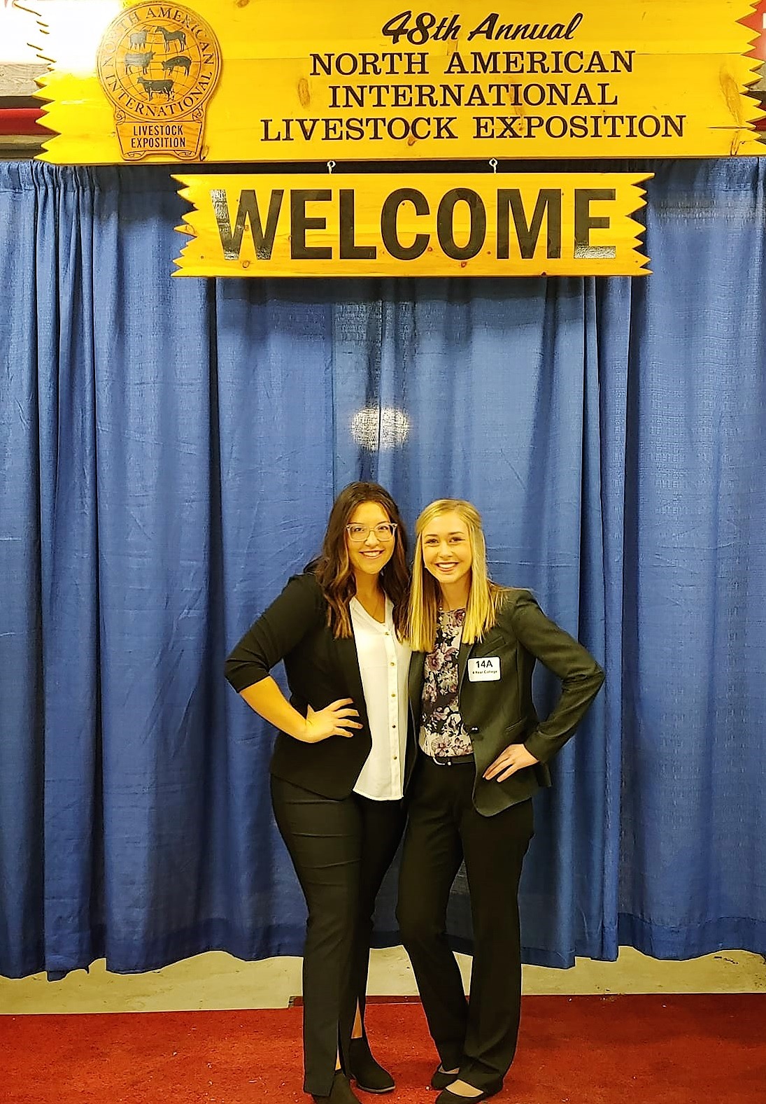 Two young people posing together at the NAILE